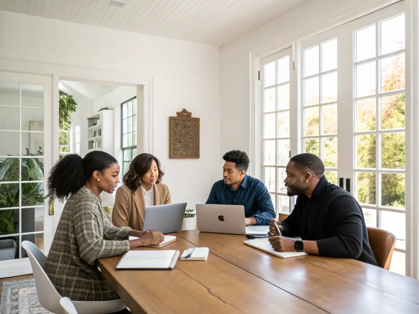 A diverse team collaborating on HR and payroll tasks in a bright, open office, representing efficient HR and payroll management.